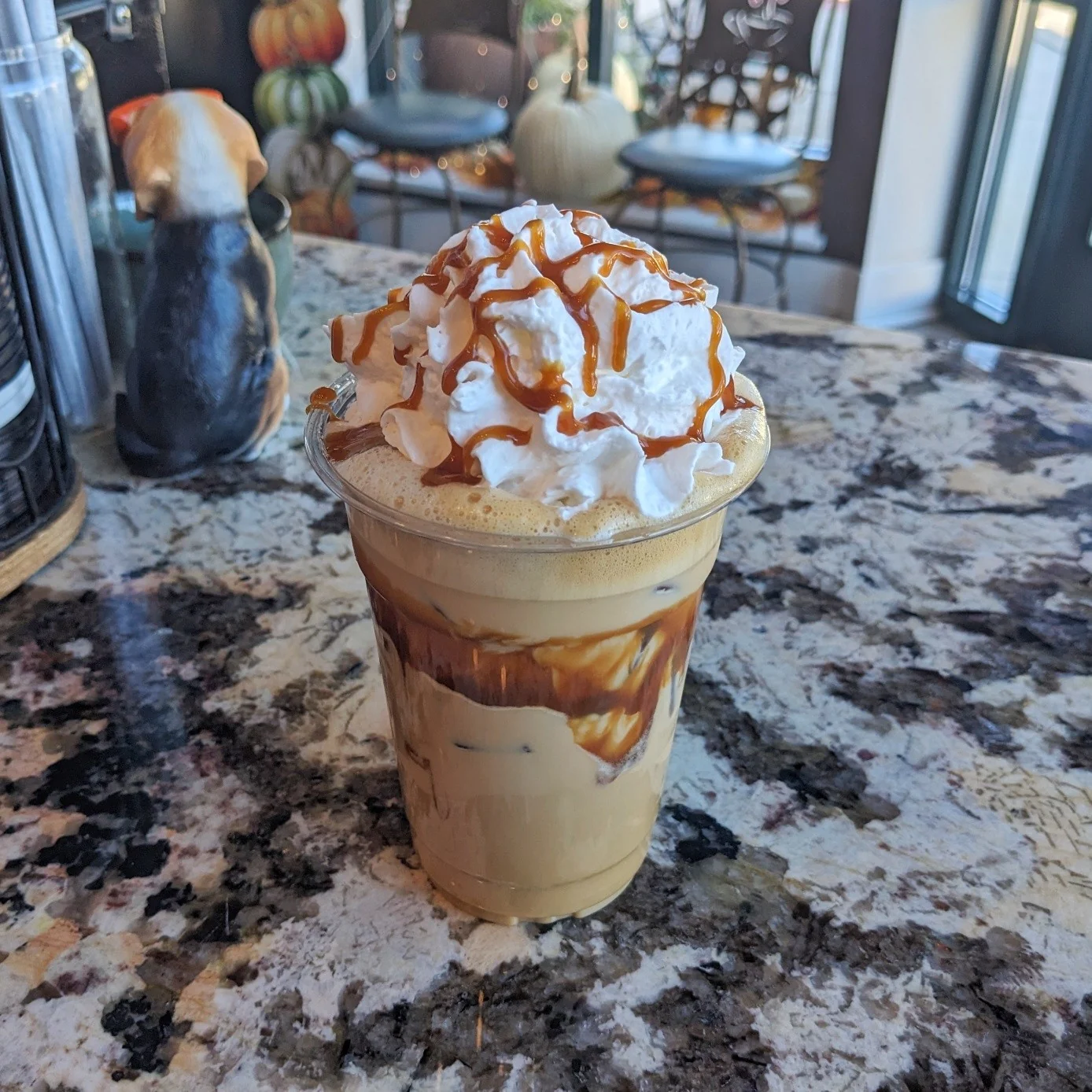 Iced caramel latte with whipped cream at Corner Grounds Café